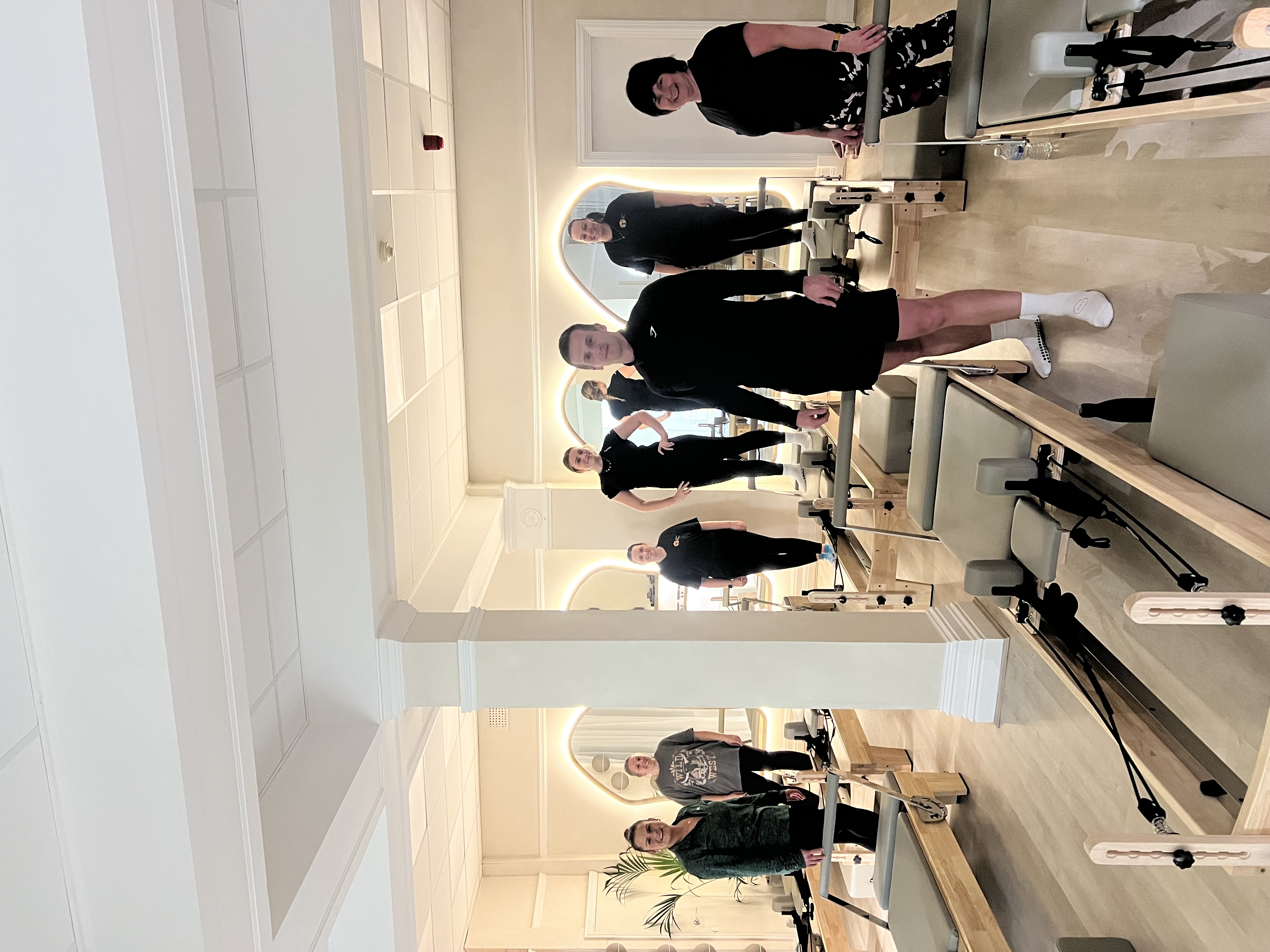 Sam's Reformer Pilates class with clients