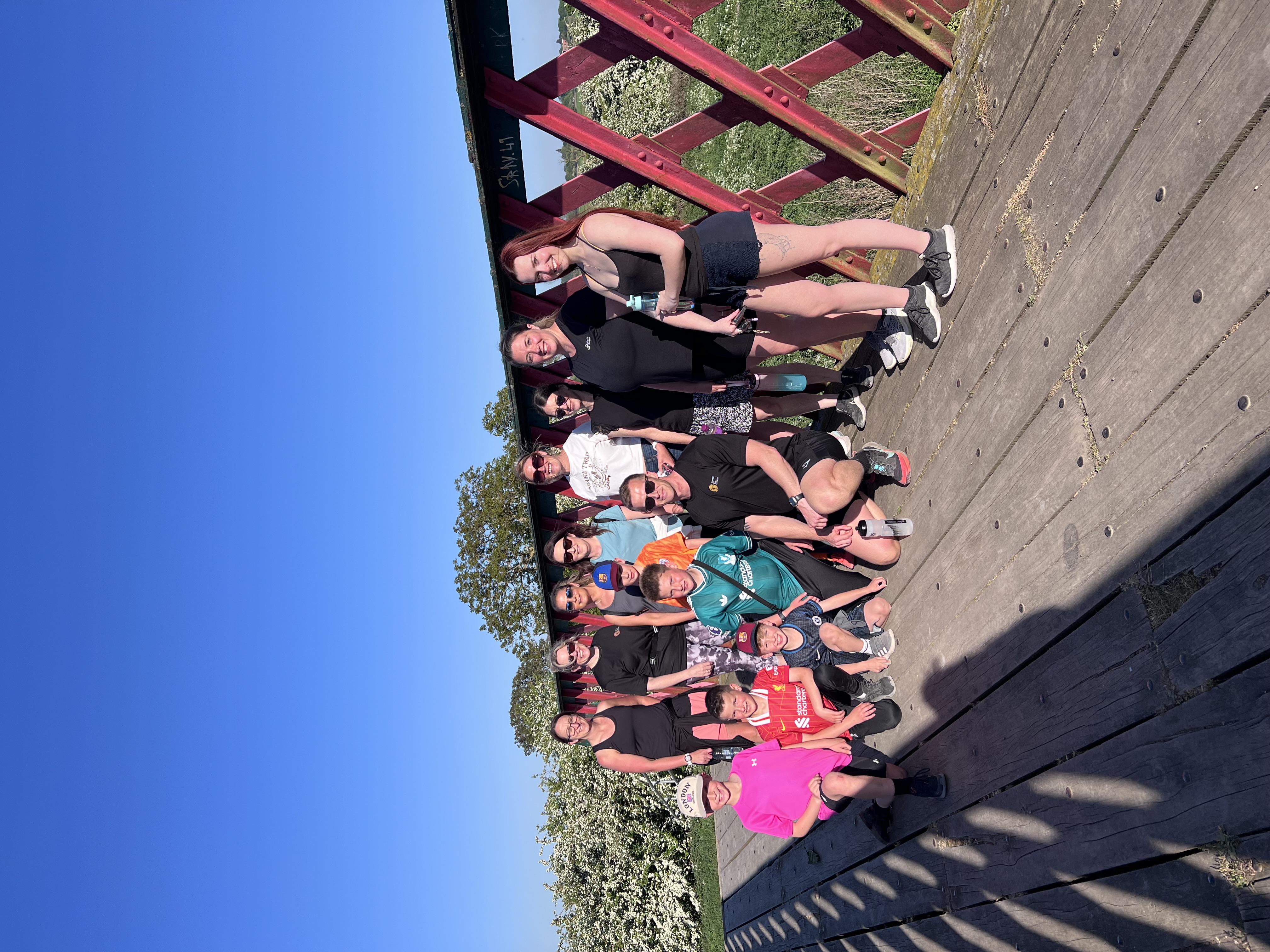 Clients on a group walk across a bridge