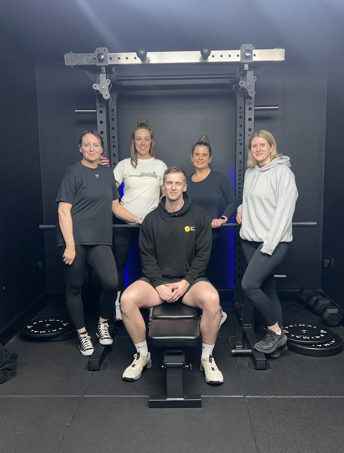 Sam with clients in the home gym