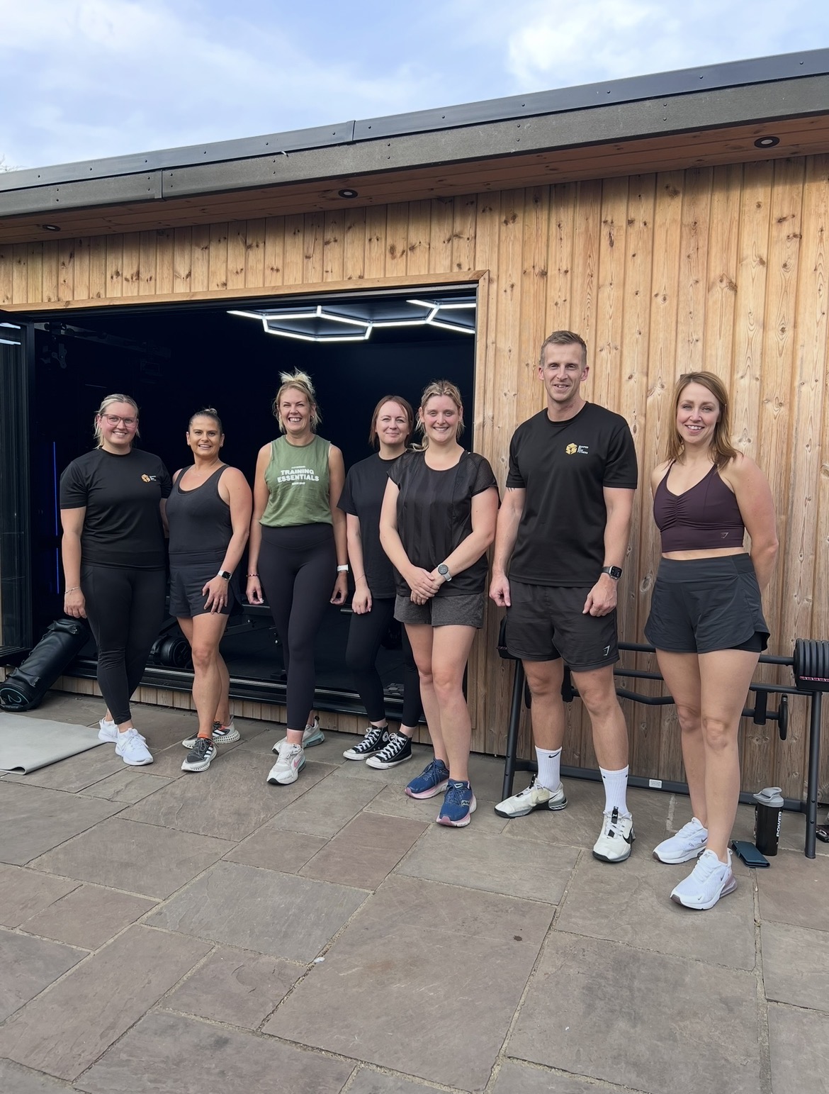 Sam with clients outside home gym