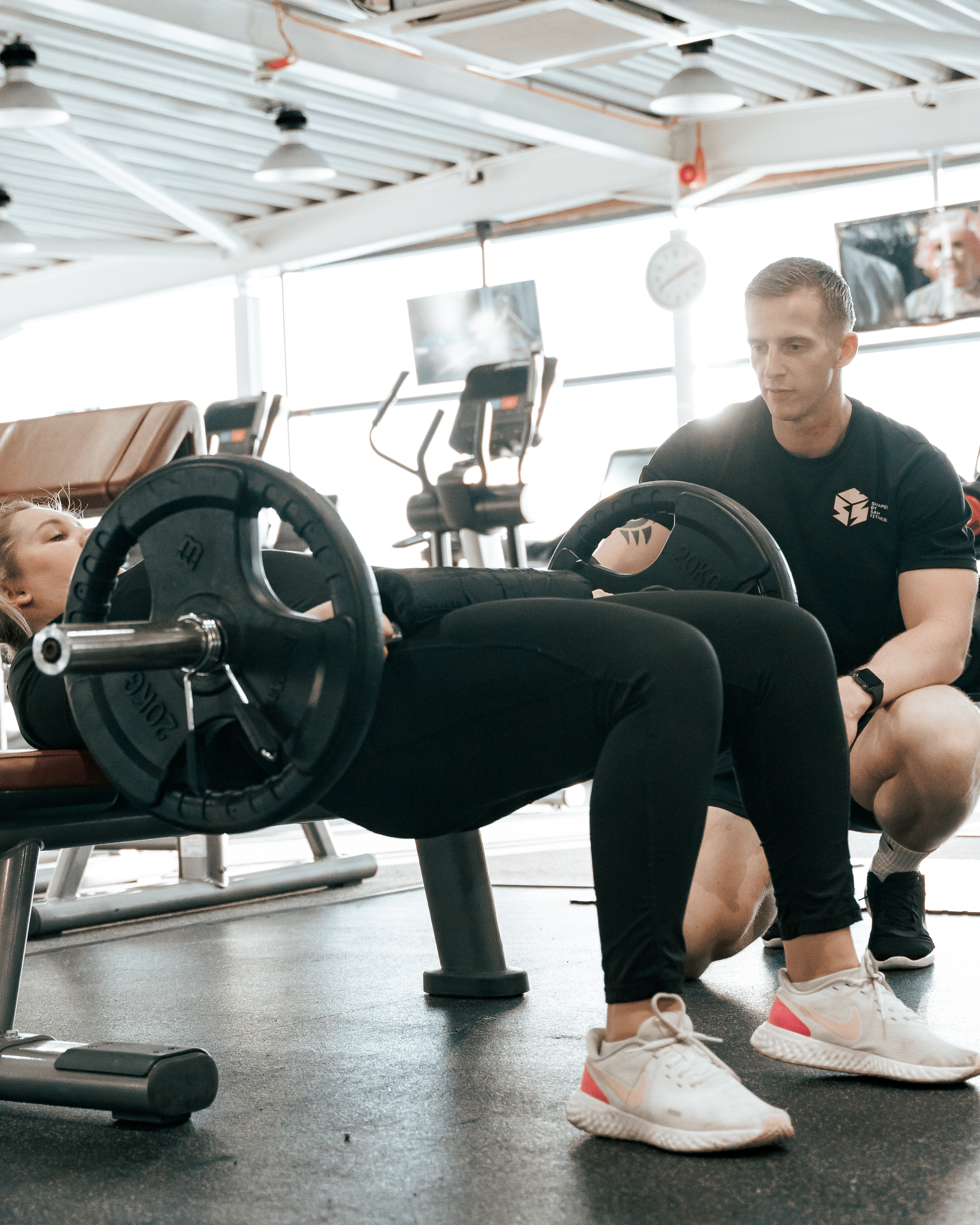 Sam spotting a client on strength training — Shaped by Sam Fitness